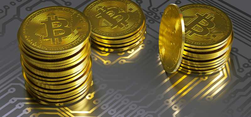 Stacks of physical gold coins marked with the Bitcoin B.