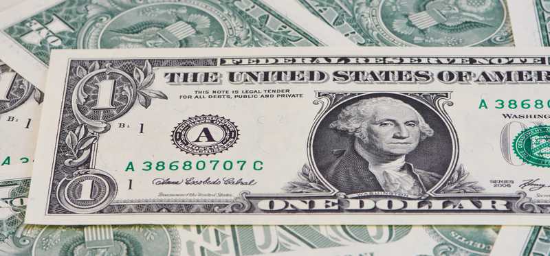 Dollar bills on a table.