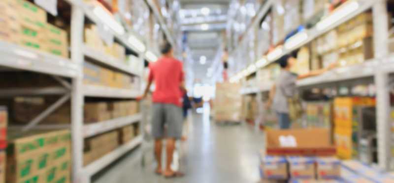 A blurred photo of an aisle in a warehouse retailer.