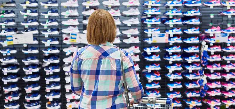 A woman shops for sneakers.