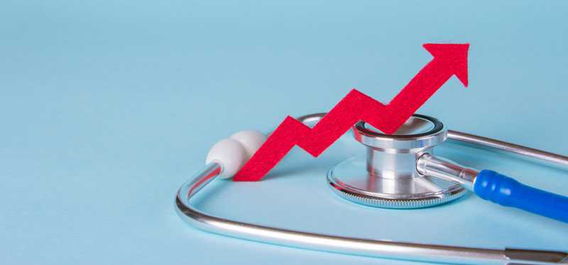 A red upward pointing line sits on top of a stethoscope.