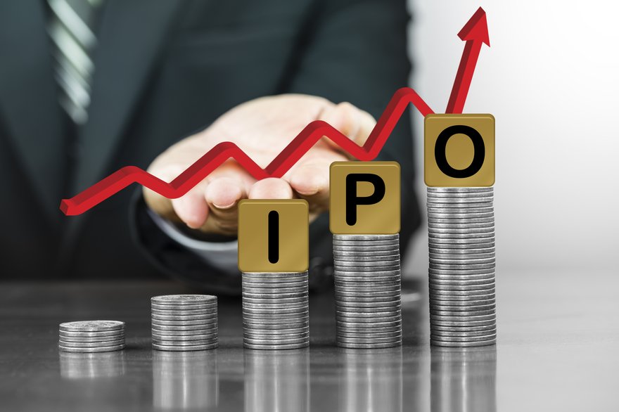 Arrow rising over blocks spelling out the letters IPO sitting atop stacks of coins.