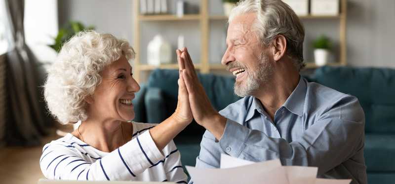 Two people giving each other a high five.