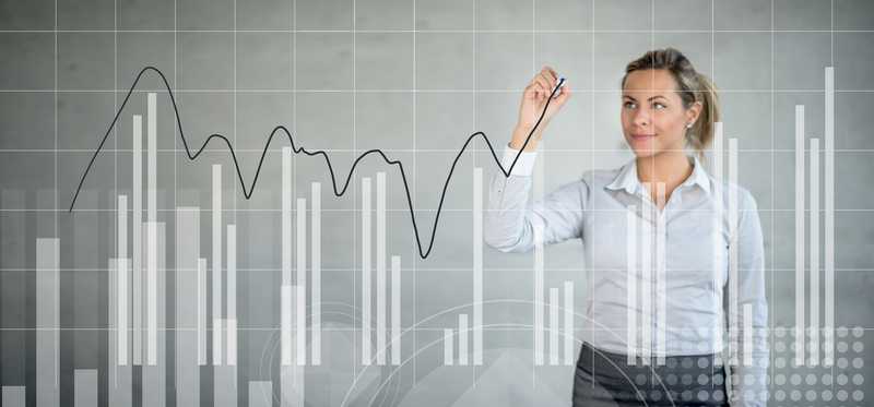 Woman tracking market movements on clear graph