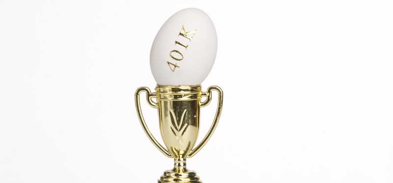 A gold trophy with an egg sticking out the top that reads 401k.