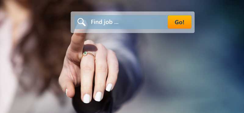 A person reaches out to touch a job search icon on a computer screen.