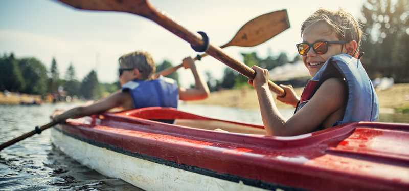 Two younger people kayaking.