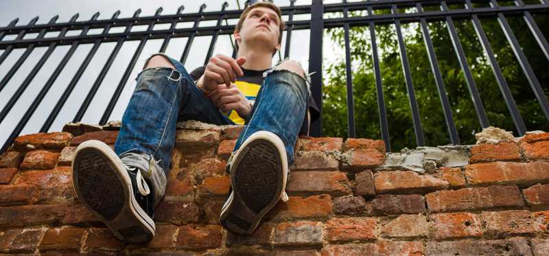 A person sitting on a brick wall in Winston-Salem, North Carolina.