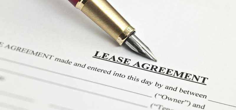 Pen lying atop a lease agreement.