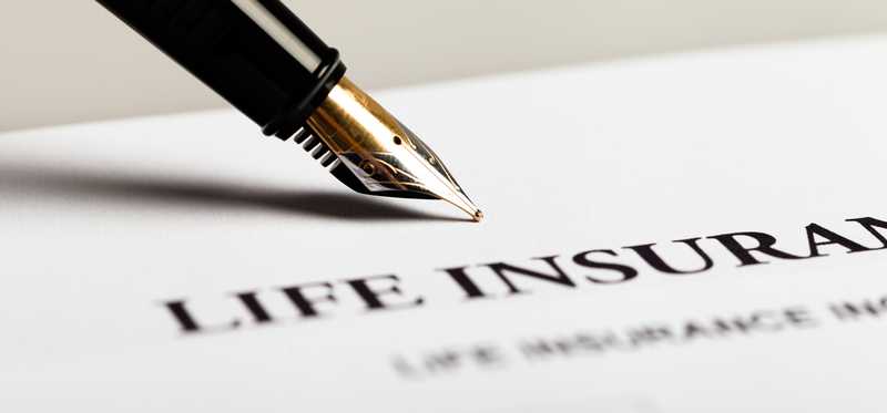 A life insurance document and ink pen.
