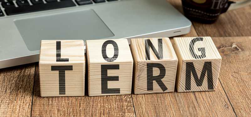 Wooden blocks spelling LONG on one face and TERM on another.