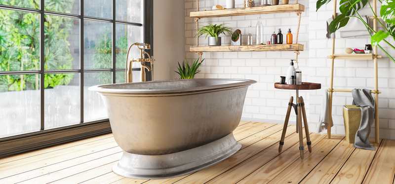 A tub sitting in front of a large window in a luxury bathroom.