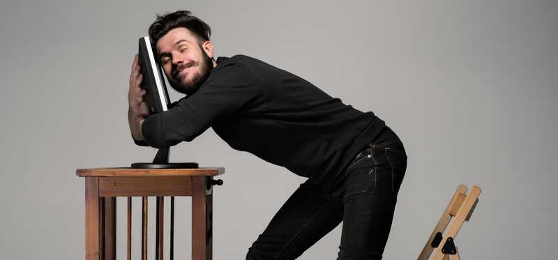 Man hugging his computer monitor.