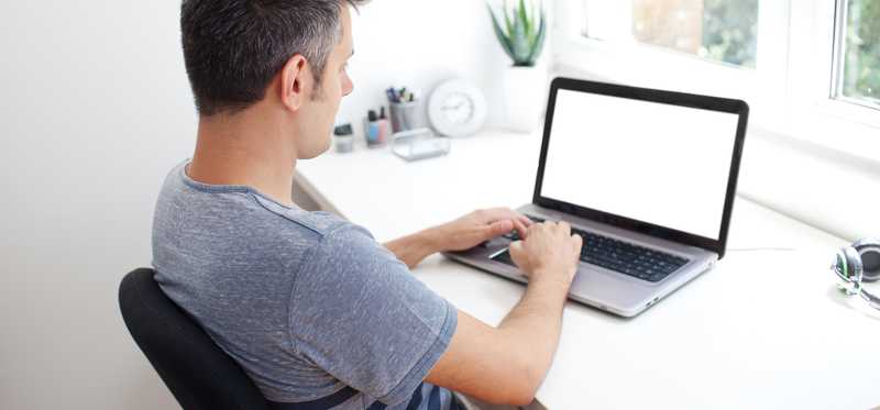 Person on laptop at home.