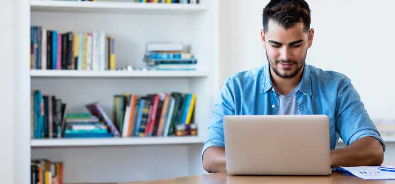 Person typing on laptop at home.