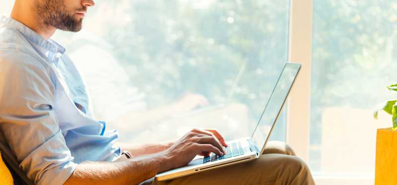 Man using laptop on his lap