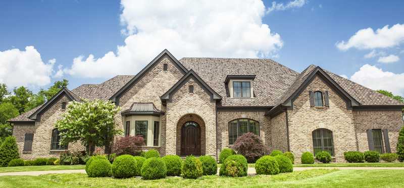 The exterior of a large brick house.