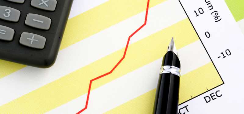 Rising red line on graph next to calculator.