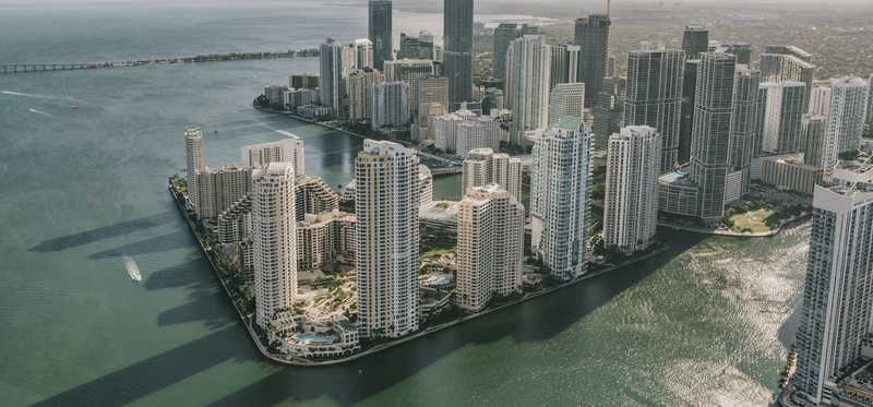 A shot of the Miami skyline with the buildings throwing shadows on the water.