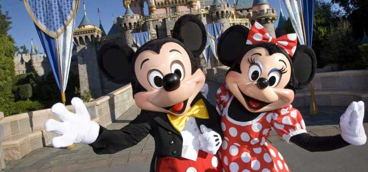 Mickey and Minnie Mouse greeting visitors to Disneyland.