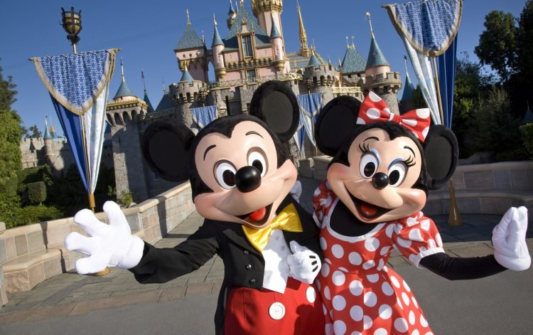 Mickey and Minnie Mouse greeting visitors to Disneyland.