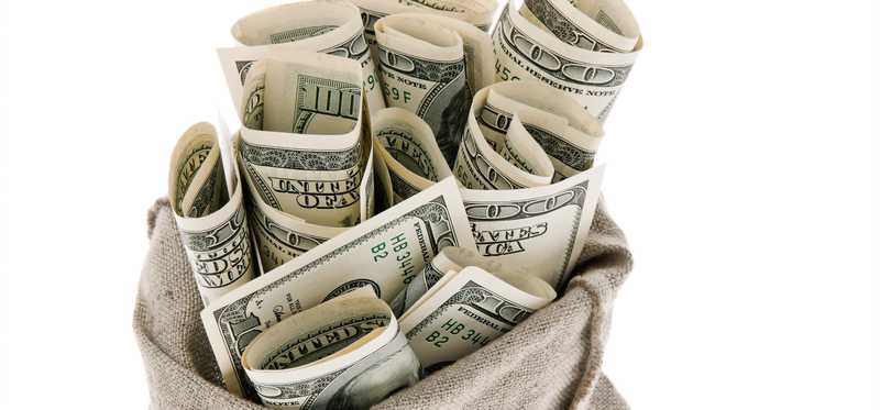 Large bills rolled up in a burlap sack.