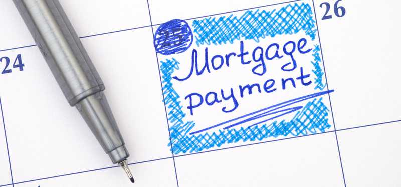 A mortgage payment marked in blue on a large calendar page.