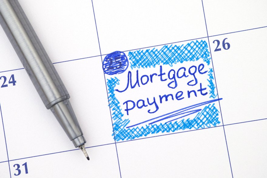 A mortgage payment marked in blue on a large calendar page.