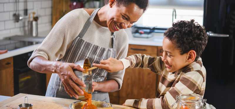 Mother and son baking together.