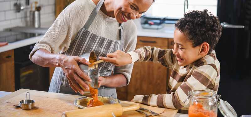 Mother and son baking together.