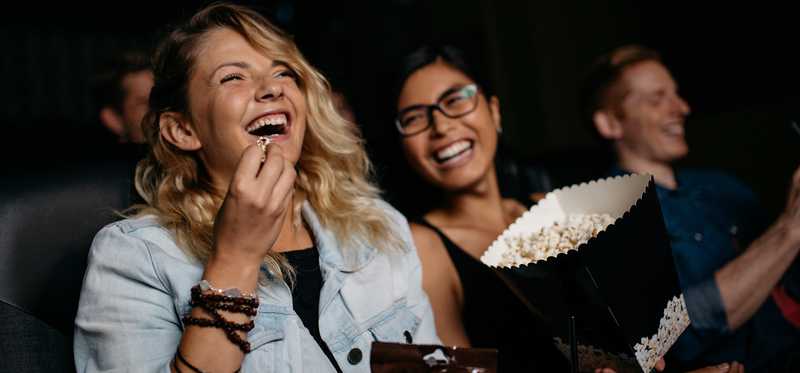 People watch a film in a movie theater.