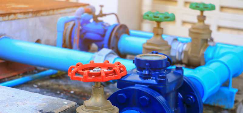 Multicolored interconnected outdoor water pipes.