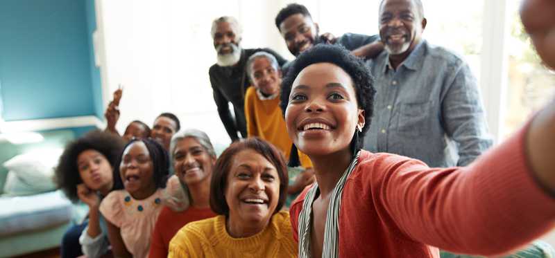 A group of people smiling for a selfie.