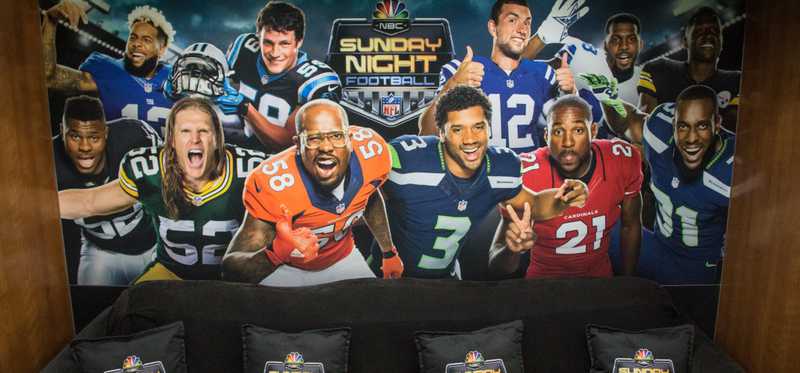 A sunday night football promo wall and couch.