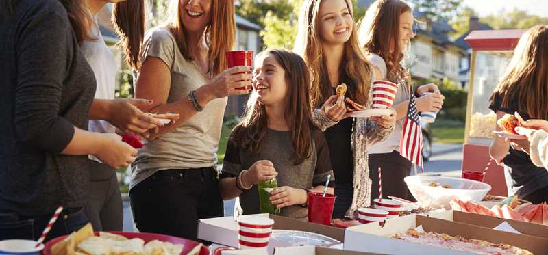 Neighbors eating food at block party