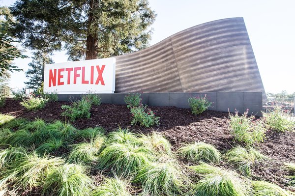 A Netflix sign outdoors in a landscaped area.