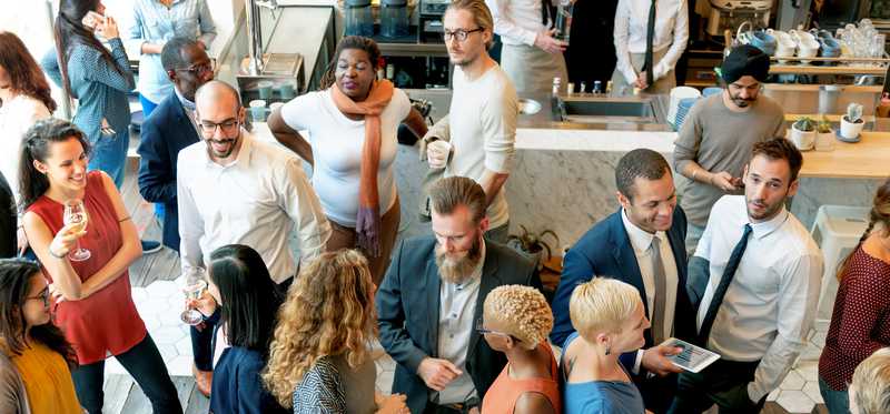 A room full of people at a networking event.