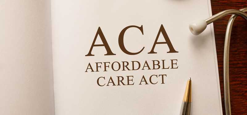 Affordable Care Act typed on a book.