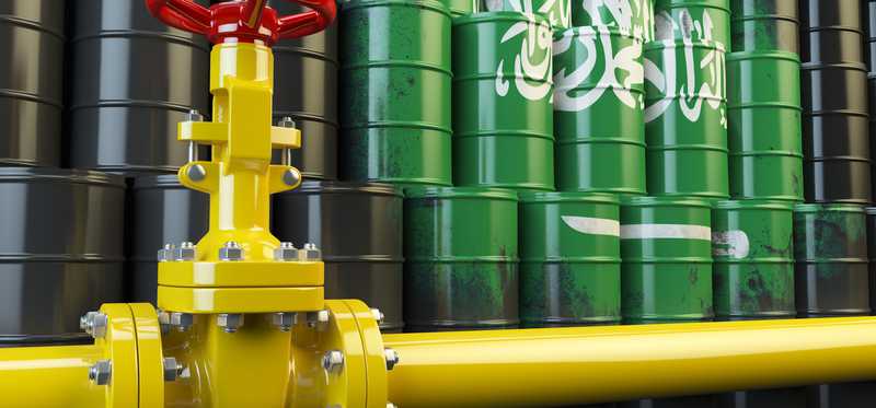 Oil pipeline valve in front of Saudi Arabia flag.