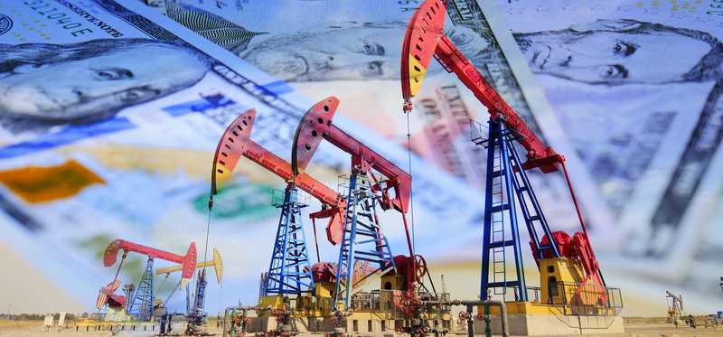 Oil pumps with money in the background.