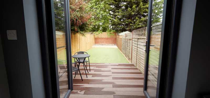 Doors open up onto patio and small yard.