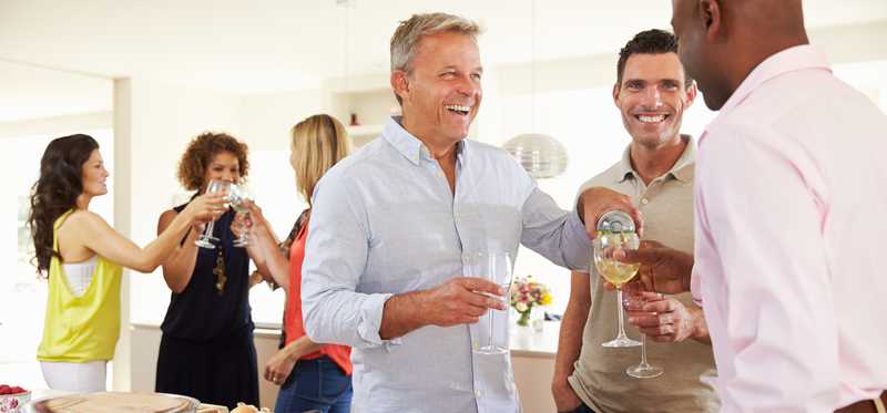 People drink wine at a party.