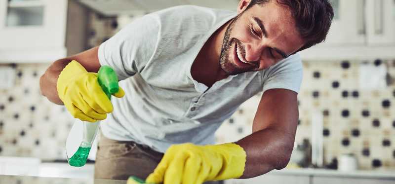 Person cleaning kitchen counter.