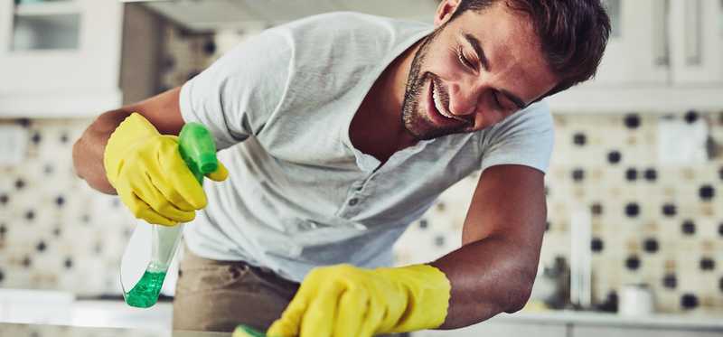 Person cleaning kitchen counter.