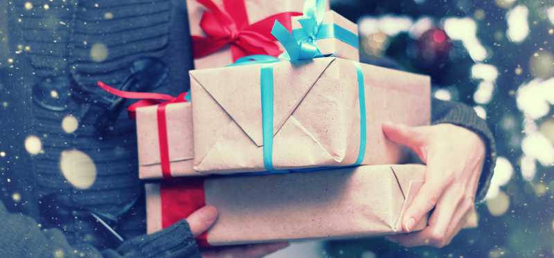 Person holding gift wrapped presents