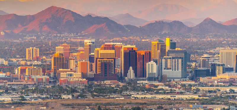 A view of the Phoenix, Arizona, skyline with mountains in the background.