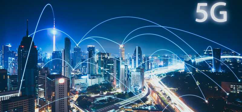 City skyline with lighted beams representing 5g connectivity.