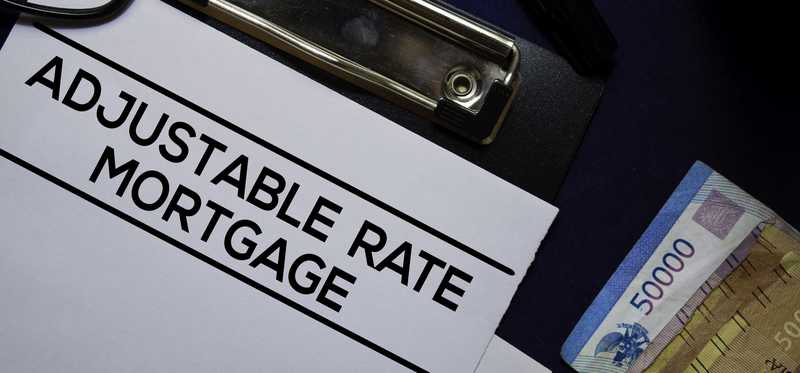 Piece of paper on clipboard that says Adjustable Rate Mortgage.
