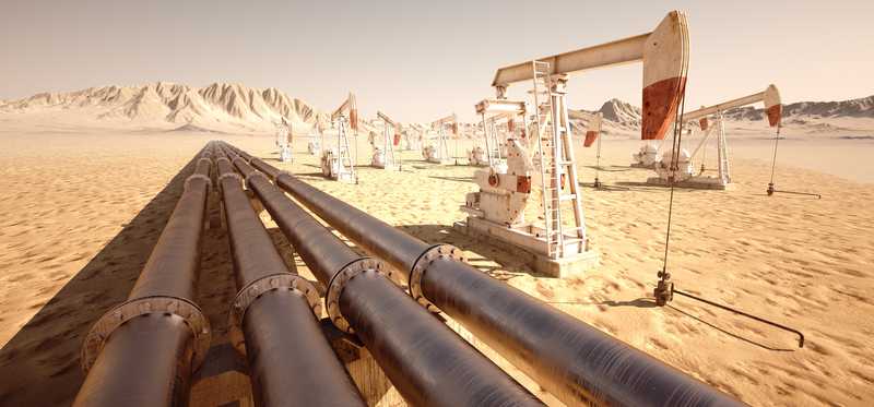 Pipelines with oil rig off in the distance.