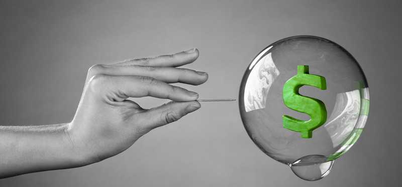 A hand extending to pop a bubble with a green dollar sign floating inside it.